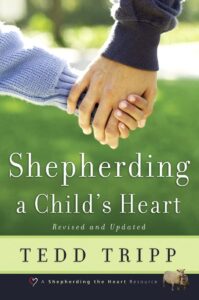 Book with parent and child holding hands with discription: Shepherding a childs heart