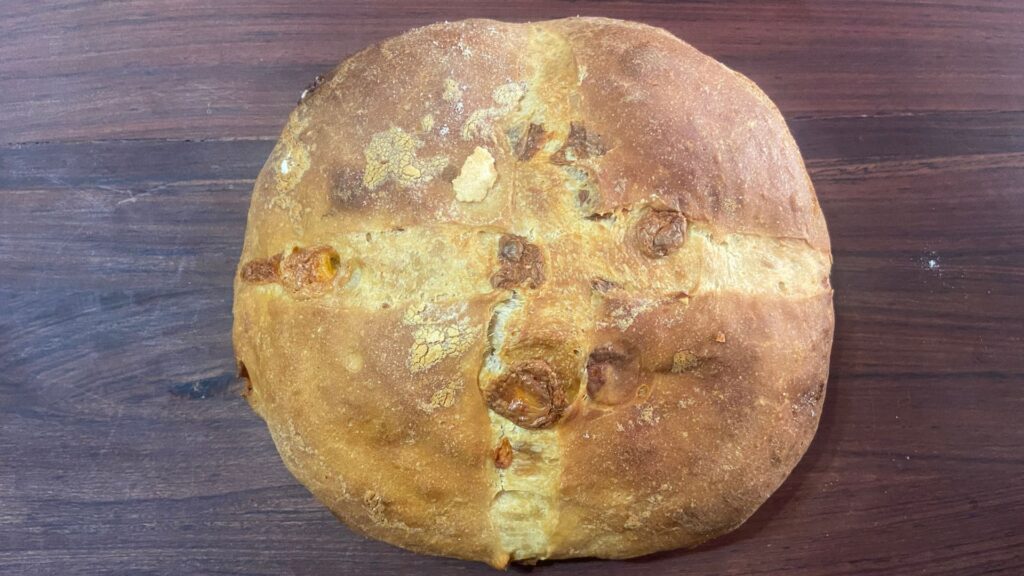 Baked Cheesy cheddar sourdough bread on wooden table