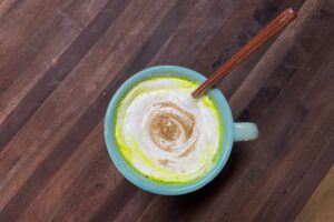 healthy spiced milk, topped with whipped cream and a dash of cinnamon
