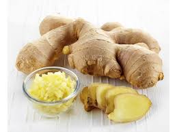 Fresh ginger on a white table, ready to add to spiced milk drink for colds, flu and sore throat.