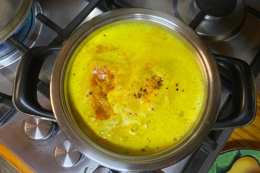 Spiced milk cooking on stovetop