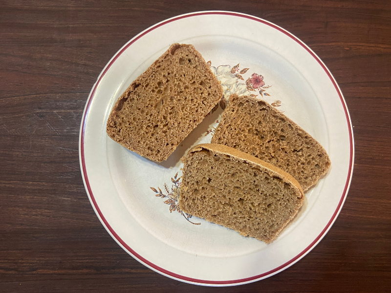 100% whole grain spelt bread sliced on a white plate