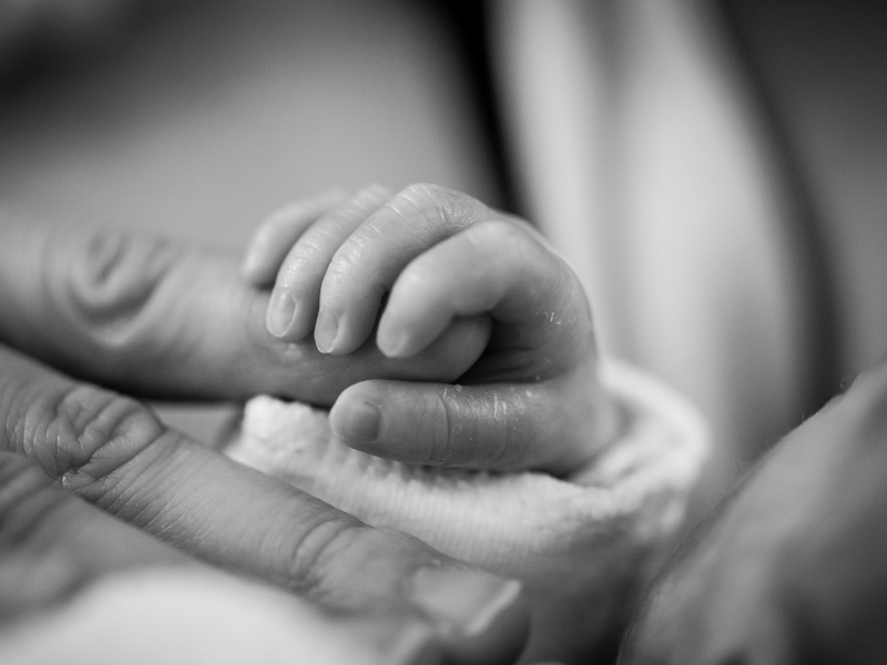 baby holding mothers finger after a positive calm homebirth