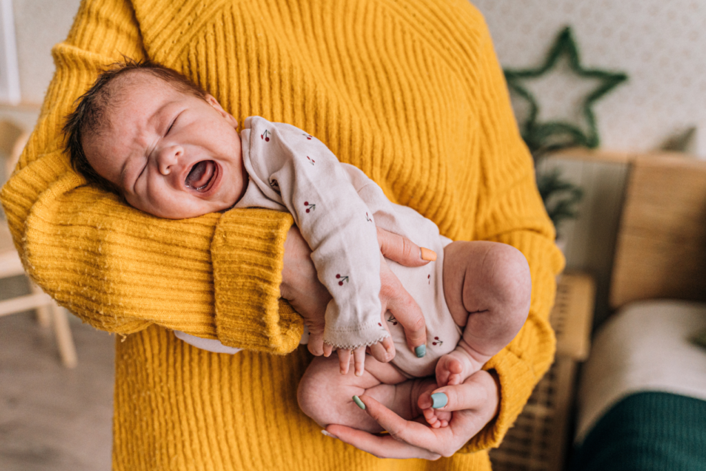 crying baby with upside down cradle hold